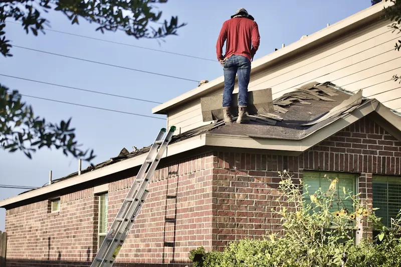 Professional roofer working on a residential roof in Brandy Chase